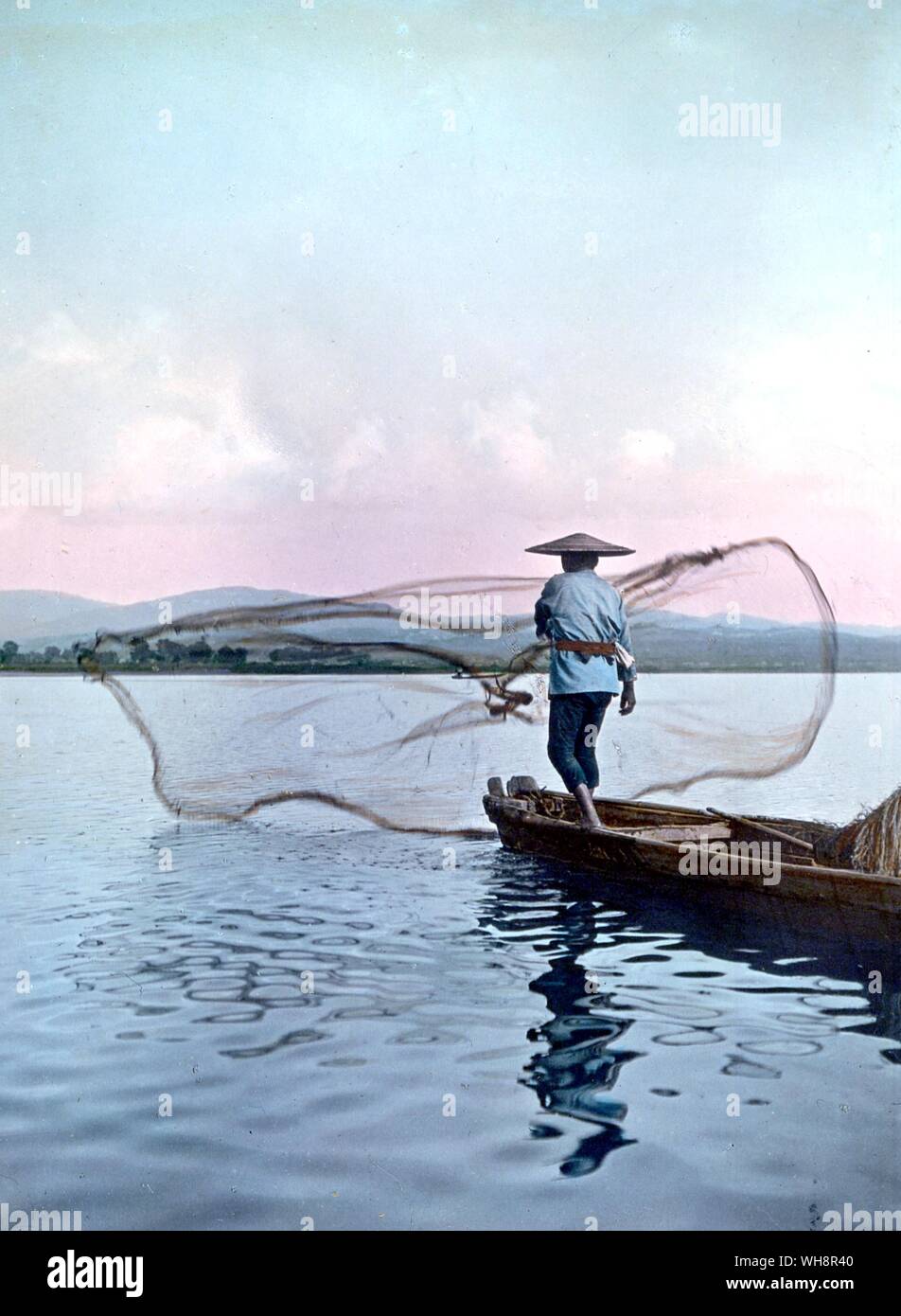 Casting a net on lake Biwa. 1906. Stock Photo