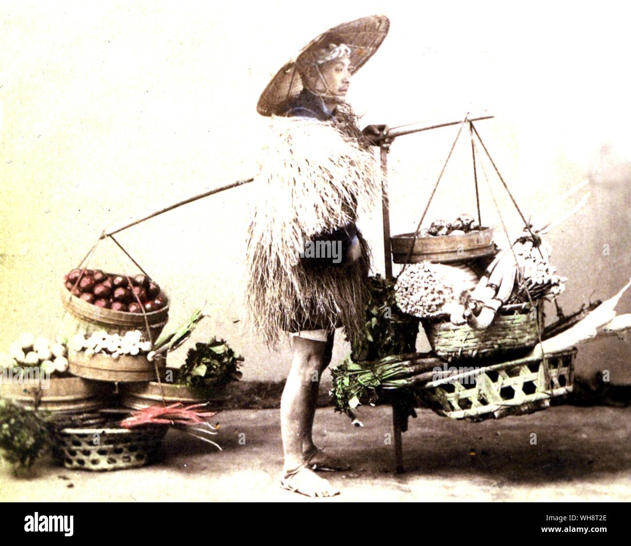 Street vendor selling vegetables. 1898 Stock Photo