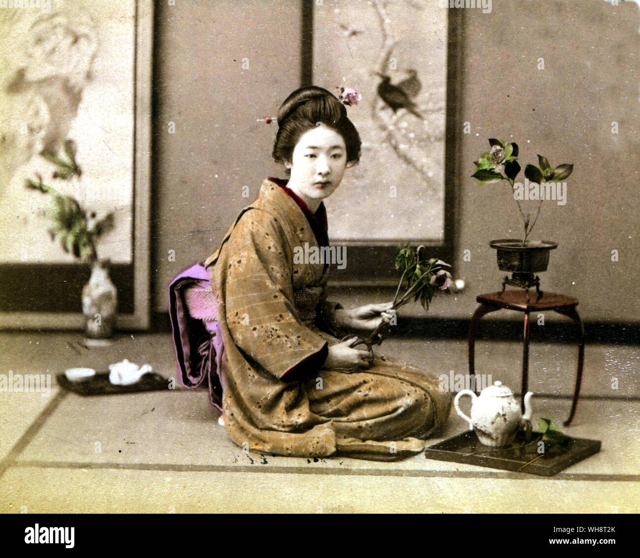 A musume serves tea. Tokyo, 1899. Stock Photo