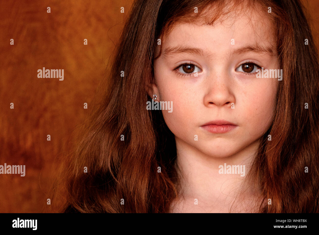 Portrait of little girl with brown hairs and eyes Stock Photo