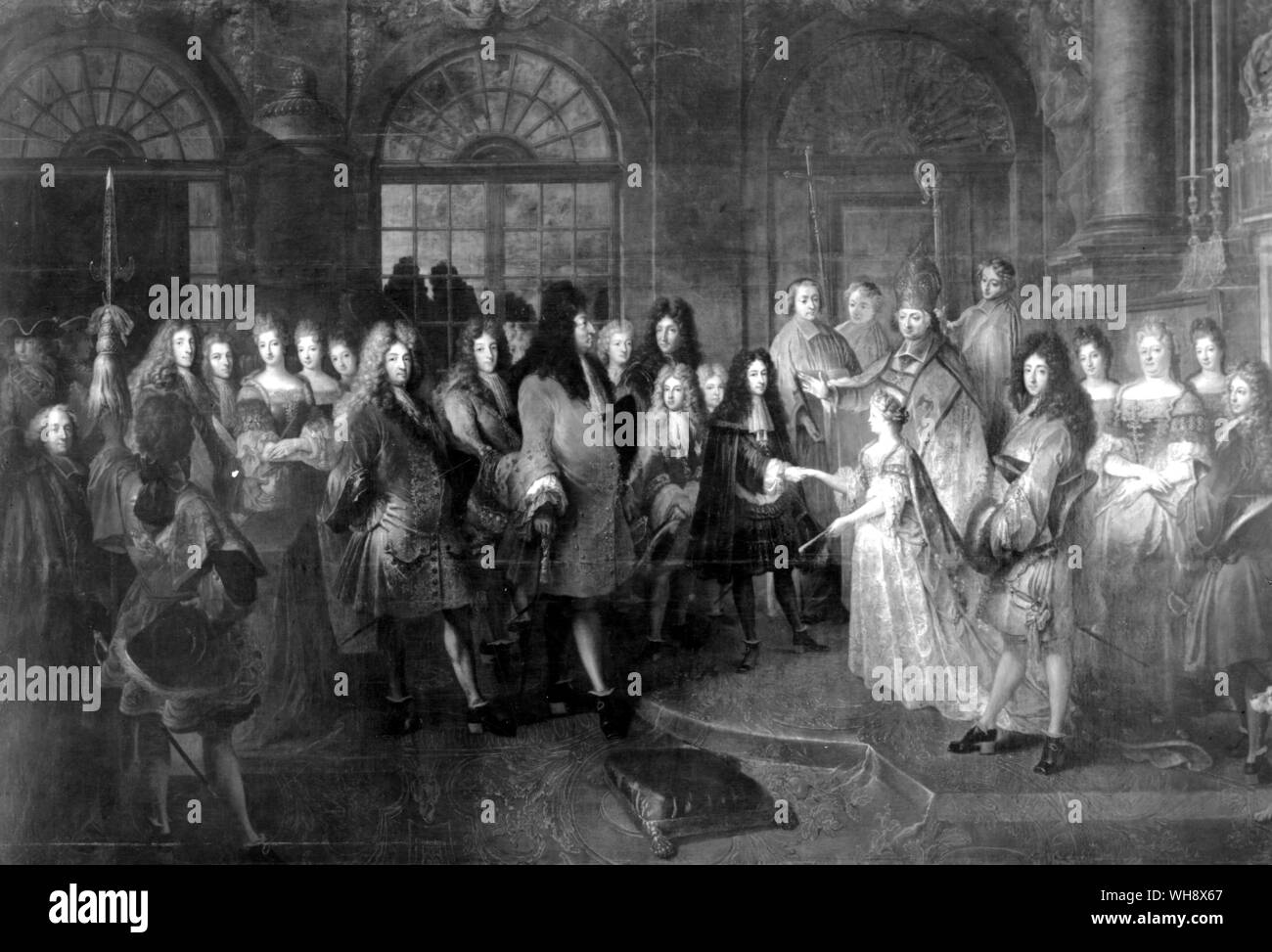 Marriage of the Duc de Bourgogne and Princess Marie-Adelaide of Savoy, 7th December 1697 by Antoine Dieu. Behind the Duc de Bourgogne are the Ducs d'Anjou and Berry. Louis is supported by a stick with his son, the grand Dauphin, be4hind him. To the right are Monsieur, with his son the Duc de Chartres and the Duchess of Orleans and Chartres. Stock Photo