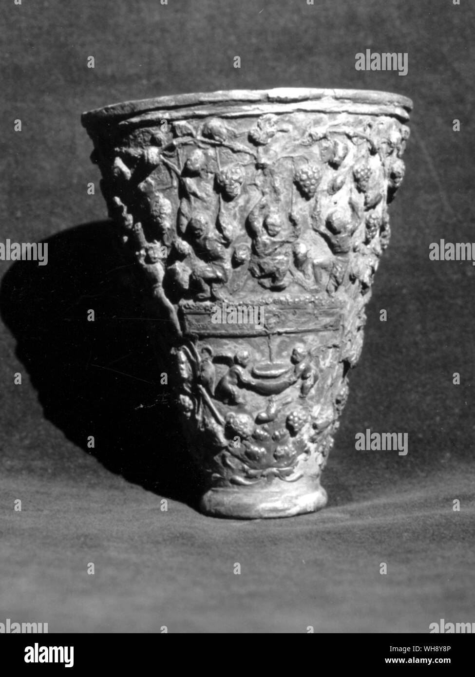 Silver-gilt drinking cup decorated with scenes from the vineyard. Greco-Roman period. Stock Photo