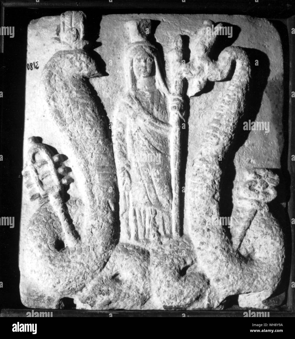 Stela with figure of Isis holding a torch between two snakes, one wearing the double crown of Egypt and holding the staff of Hermes.. Stock Photo
