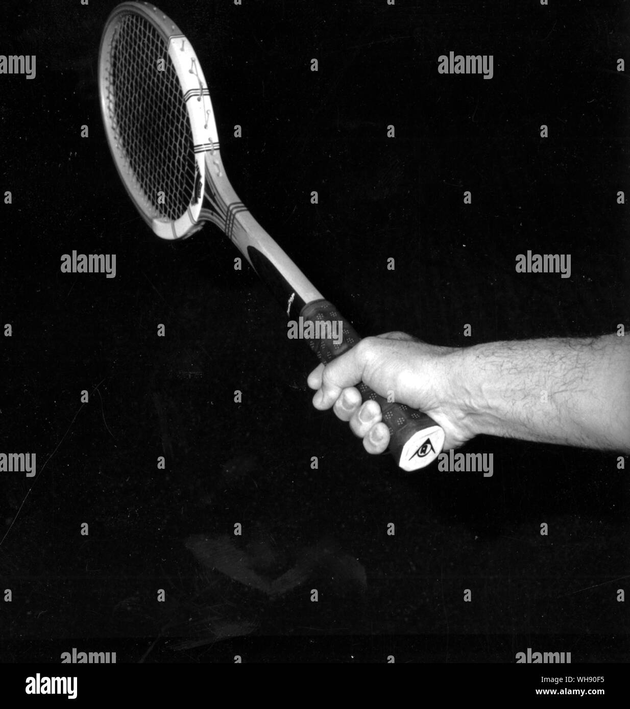 The eastern forehand grip 'shake hands' grip. The forefinger is spread slightly. Before the fingers close, the palm is parallel  with the racket face. Stock Photo