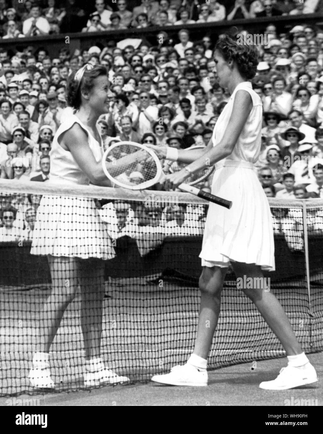 Maureen 'Little Mo' Connolly shakes hands with Doris Hart, after defeating her in the 1953 Wimbledon singles final.. Stock Photo