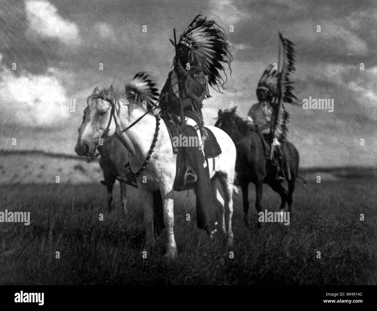 Three Sioux chiefs in war bonnets. The feathers signified various exploits.. Stock Photo