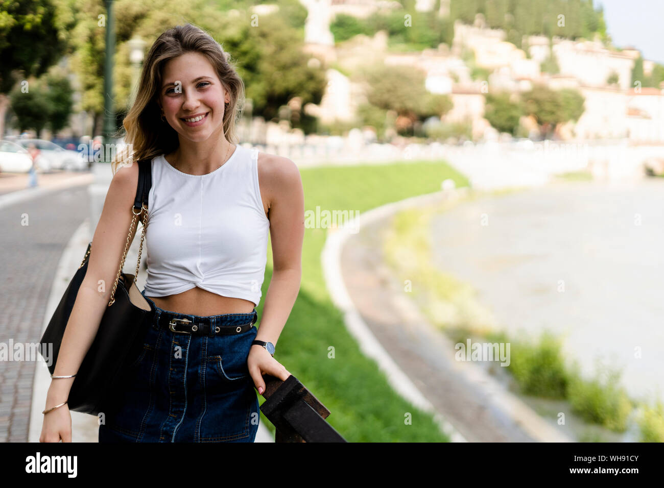 Portrait of smiling young woman enjoying summer Stock Photo - Alamy