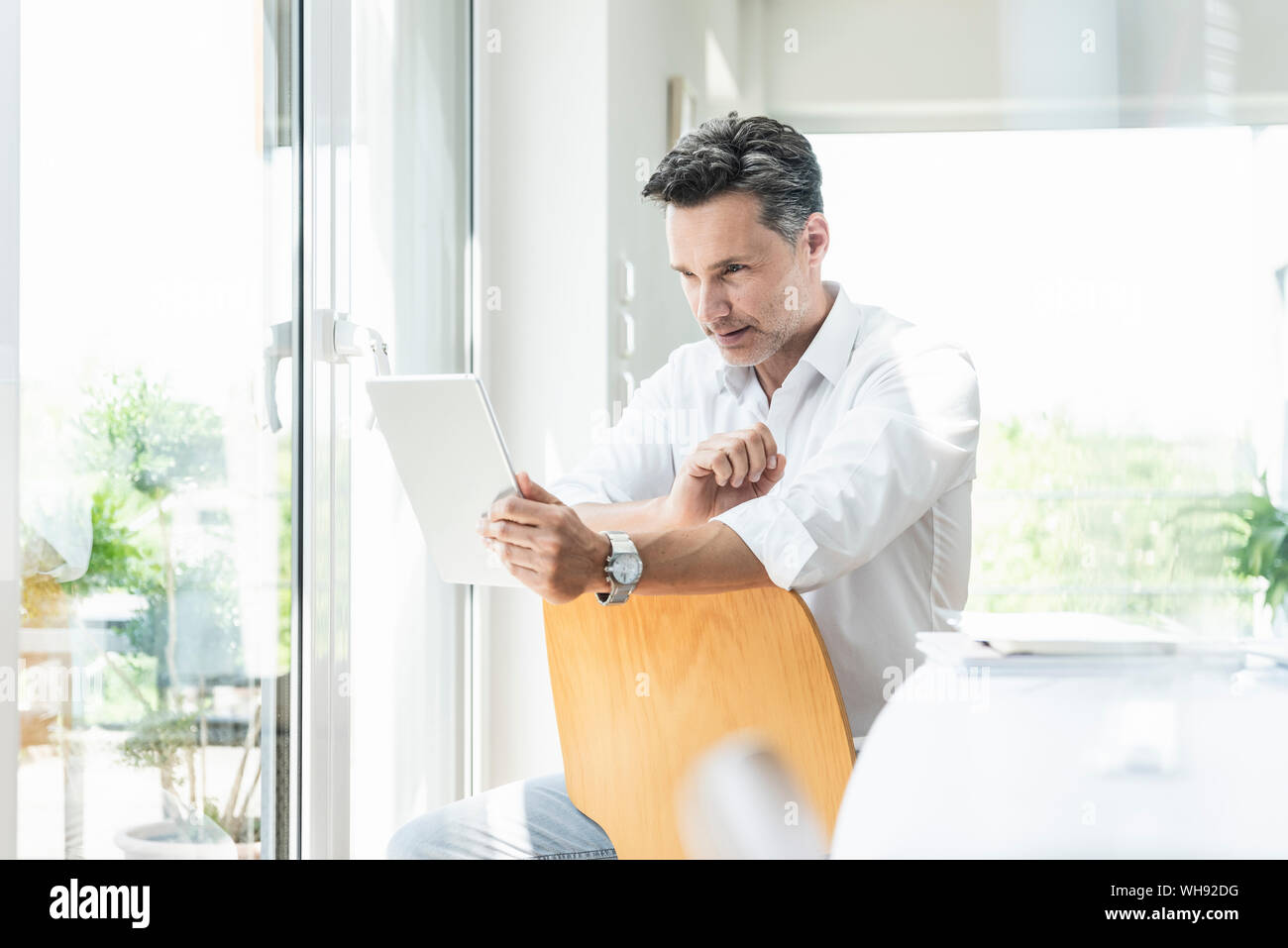 Man sitting backwards chair hires stock photography and images Alamy
