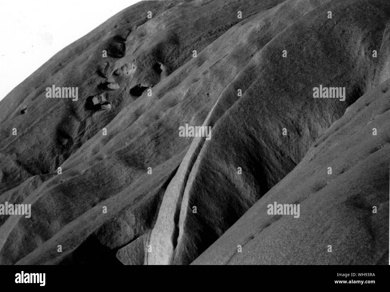 The sublime sandstone conglomerate teexture of Ayres Rock Stock Photo