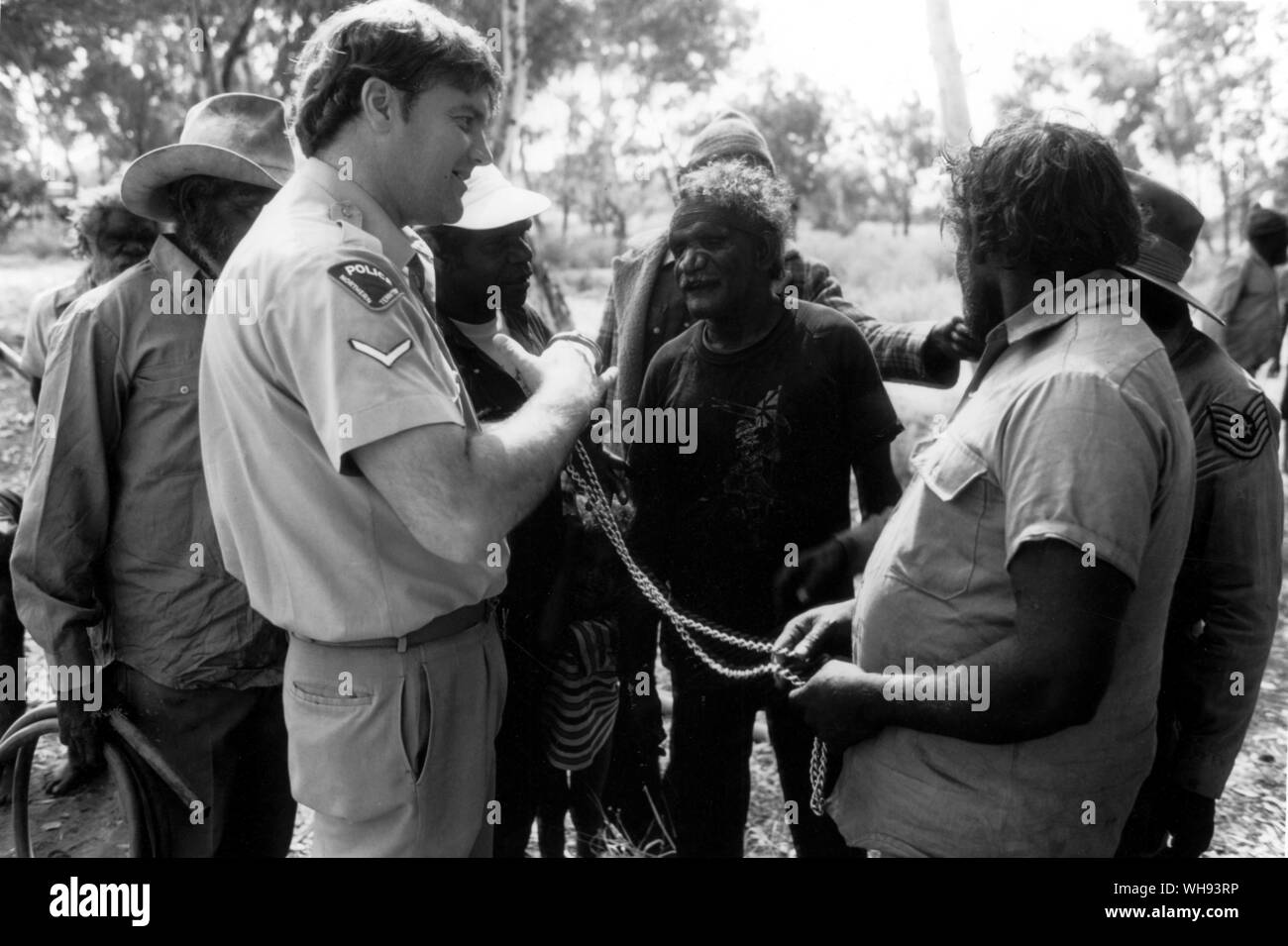 Constable Frank Morris discuss a petrol sniffing incident with the tribal council at Docker River Stock Photo