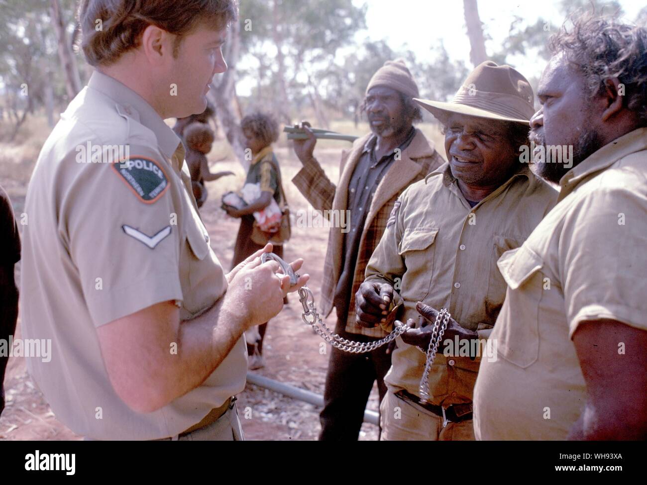 Constable Frank Morris discuss a petrol sniffing incident with the tribal council at Docker River Stock Photo