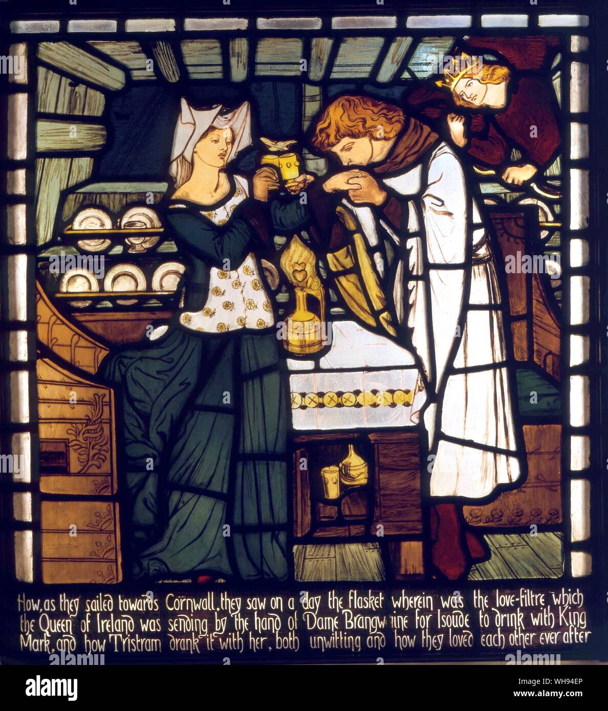 Tristan & Isolde - 1862. The Love Potion, intended for Isolde the Fair and King Mark of Cornwall, but drunk by Tristan and Isolde the Fair, from 'The Story of Tristan and Isolde', stained glass window from the Music Room, Harden Grange, nr. Bingley, Yorkshire, designed by Dante G. William Morris (March 24, 1834 - October 3, 1896) was one of the principal founders of the British Arts and Crafts movement and is best known as a designer of wallpaper and patterned fabrics, a writer of poetry and fiction, and a pioneer of the socialist movement in Britain near London.. Location © Bradford Art Stock Photo