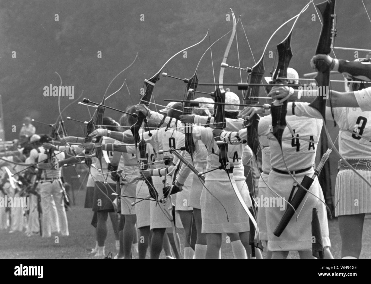 Competitors line up with bows strung at the start of the women's