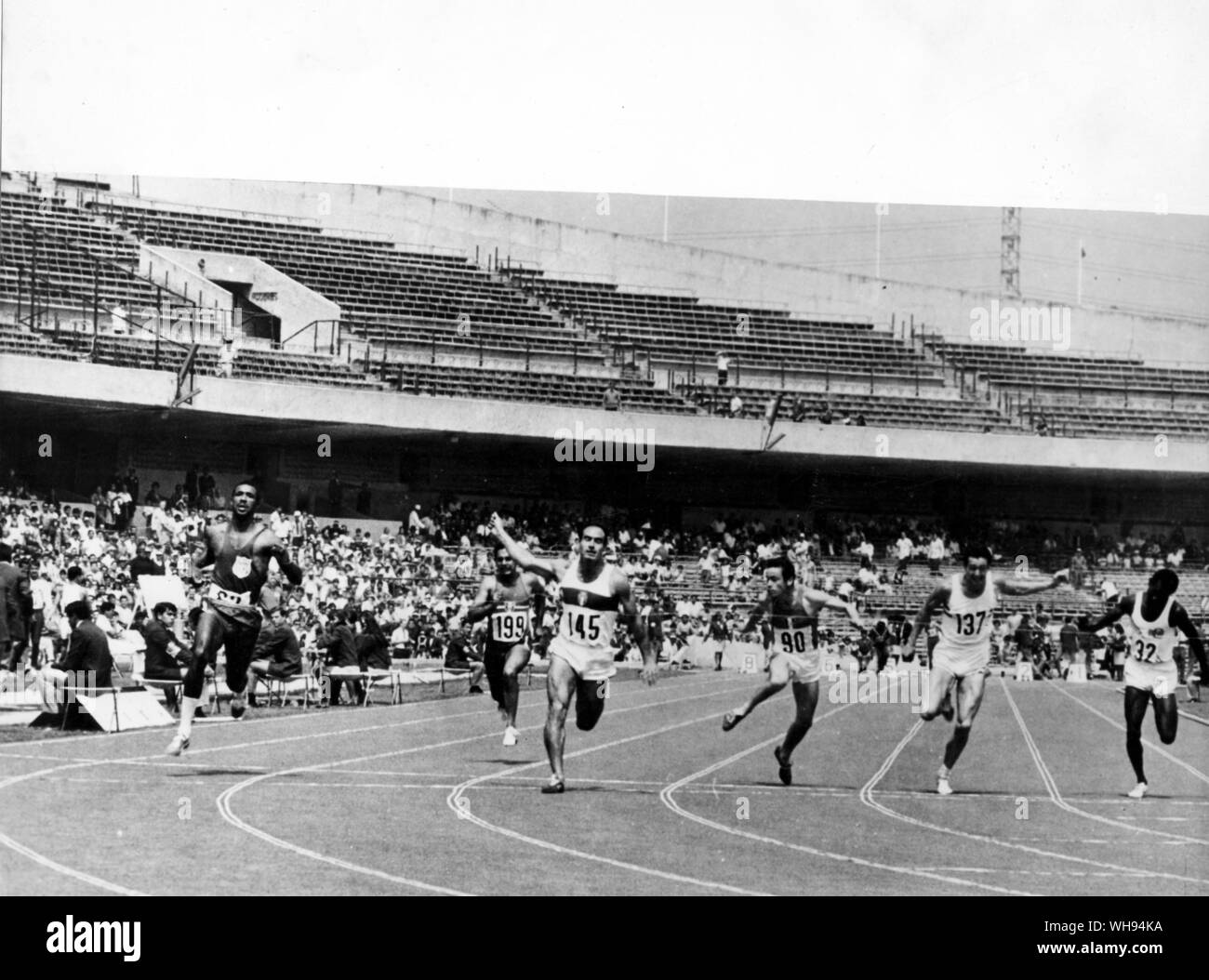 Mini-Olympics in Mexico City 1967: University Stadium. Third heat in the 100 metres sprint event in the mini-Olympic games. is P Giannattasio of Italy in 10.1 seconds who won the race. Frank Covelili of USA was second. #90 is Jean Ramond was third. is Lynn Davies of Great Britain who was fourth. Stock Photo