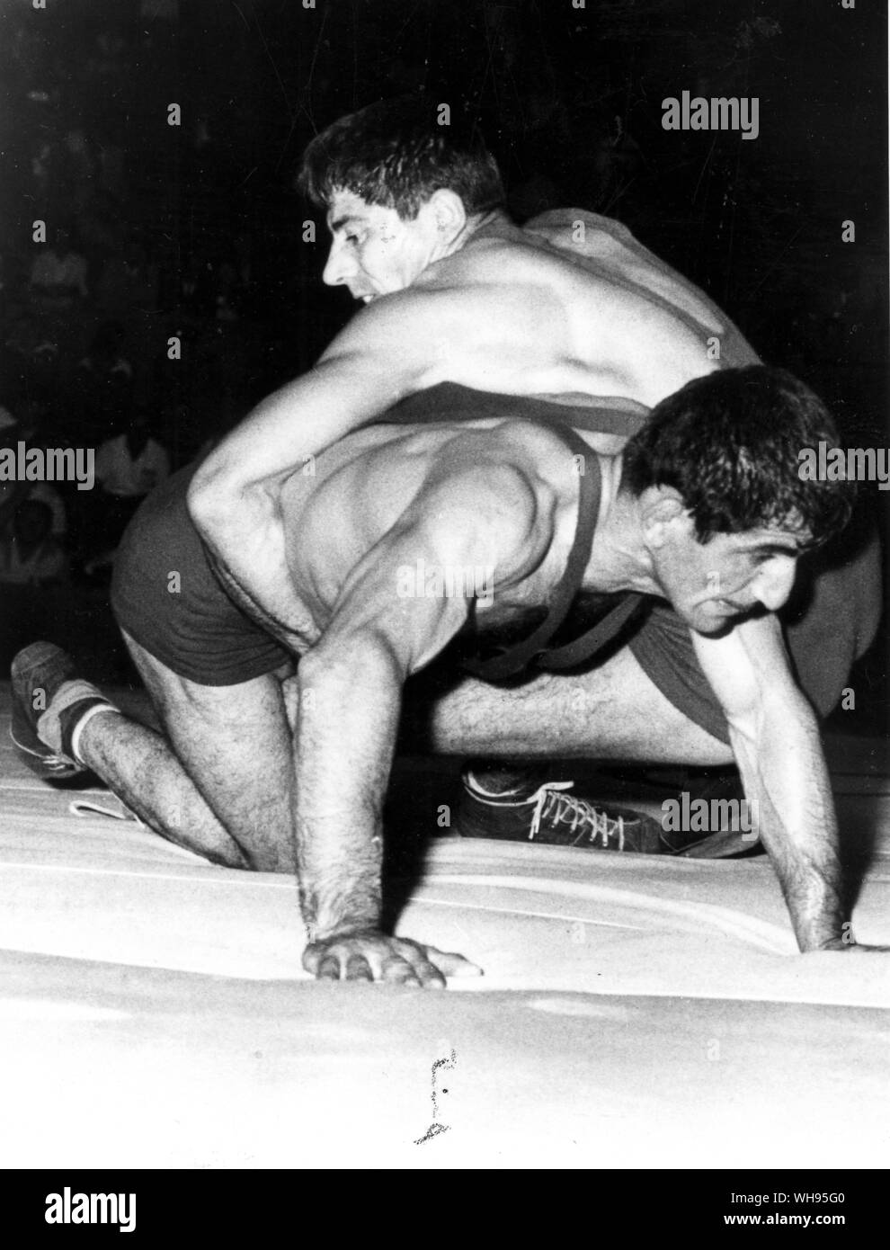 Italy, Rome, Olympic Games, 1960: Mithat Bayrak of Turkey (lower) and Rene Schiermeyer of France during their bout in the welterweight class in the Greco-Roman wrestling competition. Bayrak took the gold medal with German, Maritschnig in second place.. Stock Photo