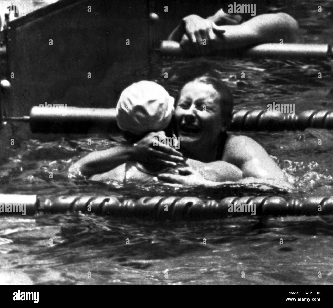 Japan, Tokyo Olympic Games, 1964: galina Prozumenschikova (USSR) facing the camera, hugs a competitor after she won the women's 200m breaststroke final in a new Olympic record time of 2:64.4 . Stock Photo