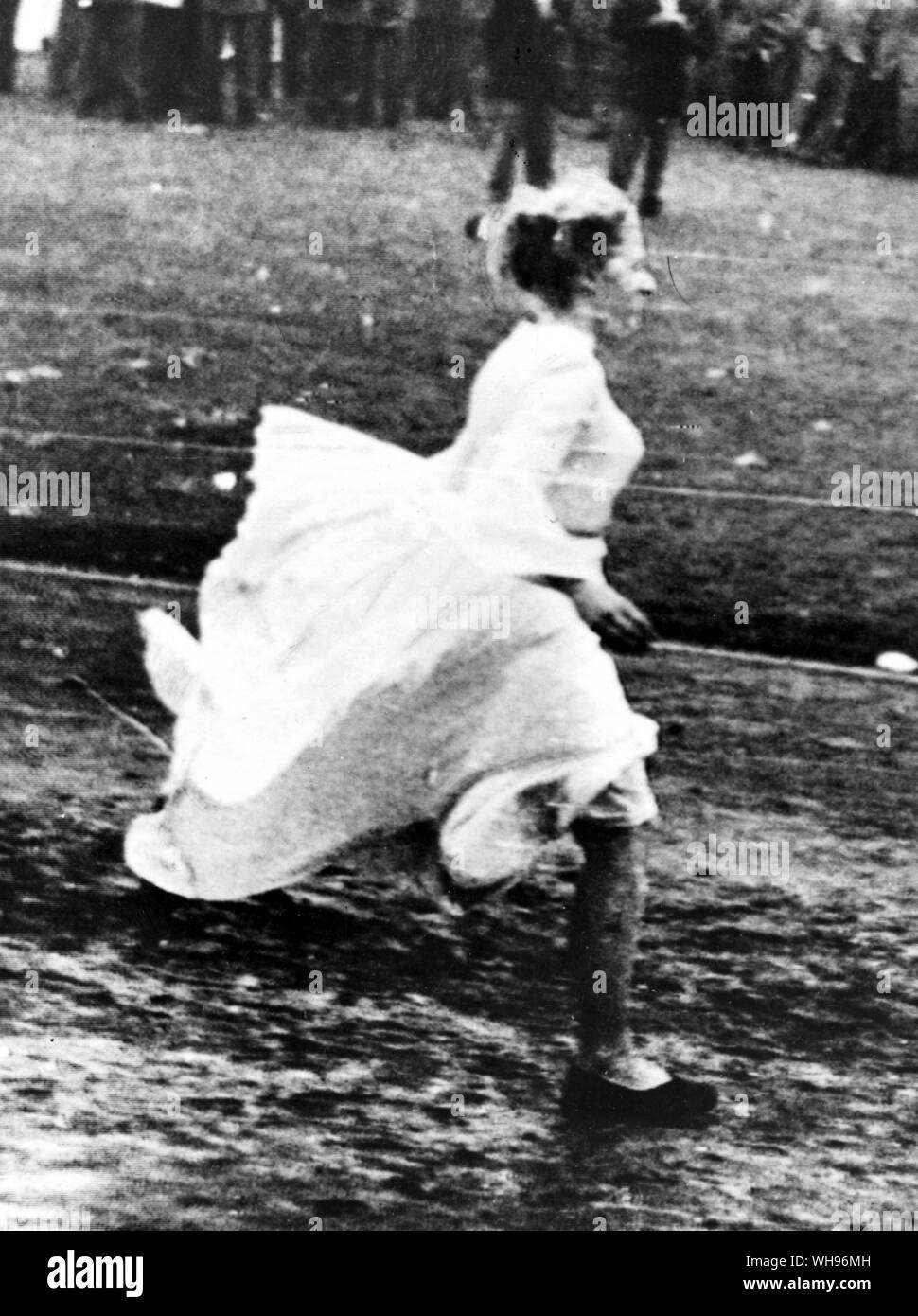 Finland,Helsinki/ Olympics,1952: Barbara Pleyer runs towards the podium in an attempt to take the Olympic oath during the opening ceremony. She was a student and had tried to get an audience with the President of Finland. She was escorted from the podium before she say two sentences! Stock Photo