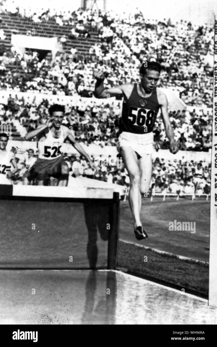 Italy, Rome, Olympic Games, 1960: Nikolai Sokolov takes the water splash ahead of Poland's Zdzislaw Krzyszkowiak in the 3000m steeplechase at the Olympic stadium, but the Pole finished first in the race and the Russian, second.. Stock Photo