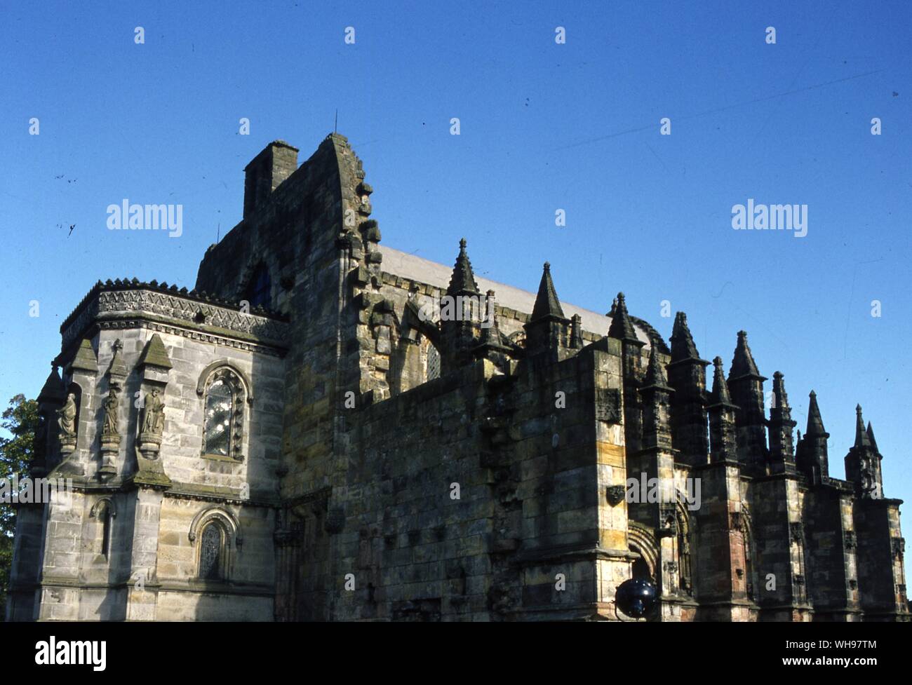 Roslin Chapel, Lothian, Scotland. The Roslin Chapel contains the 'Prentice Pillar', a remarkable carved pillar which is said to contain the Holy Grail. According to Wolfram von Eschenbach's 'Parzival', the grail was kept in a Holy Temple where it was guarded by the Templiesen. The Temple is thought by Knight and Lomas to be the Temple of Solomon in Jerusalem, where the treasures of the Jewish people were buried before the destruction of Jerusalem in 68 AD.. The Templiesen are the Monastic Order fo the Knights Templar, supposedly heirs to this hidden treasure which they recovered while on Stock Photo