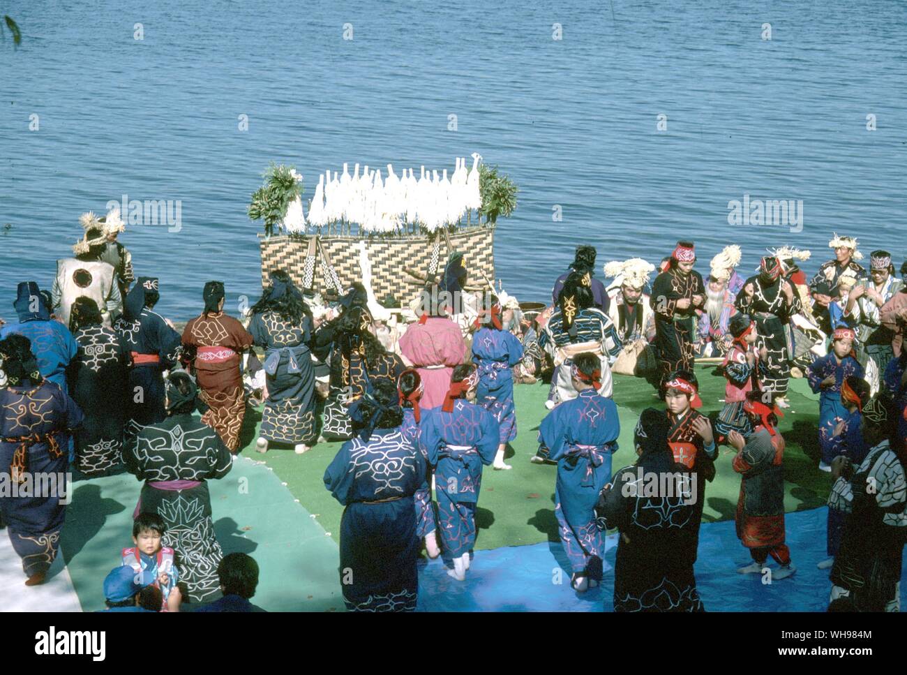 On the shores of Lake Akan the Ainu celebrate the protection of the marimo. In the centre of the altar are the marimo and at the back are inau, the sacred offerings to the Kamui made by whittling short branches Stock Photo