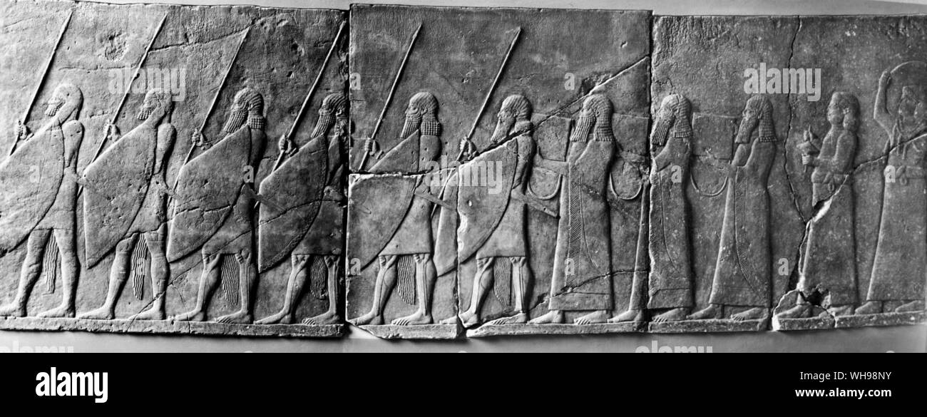 Warfare/Iran. Nineveh. Palace of Sanherils, Sennacherib. Wall covering showing a festive march - fully armed men are followed by men with instruments and musicians. 7th century B.C. Stock Photo