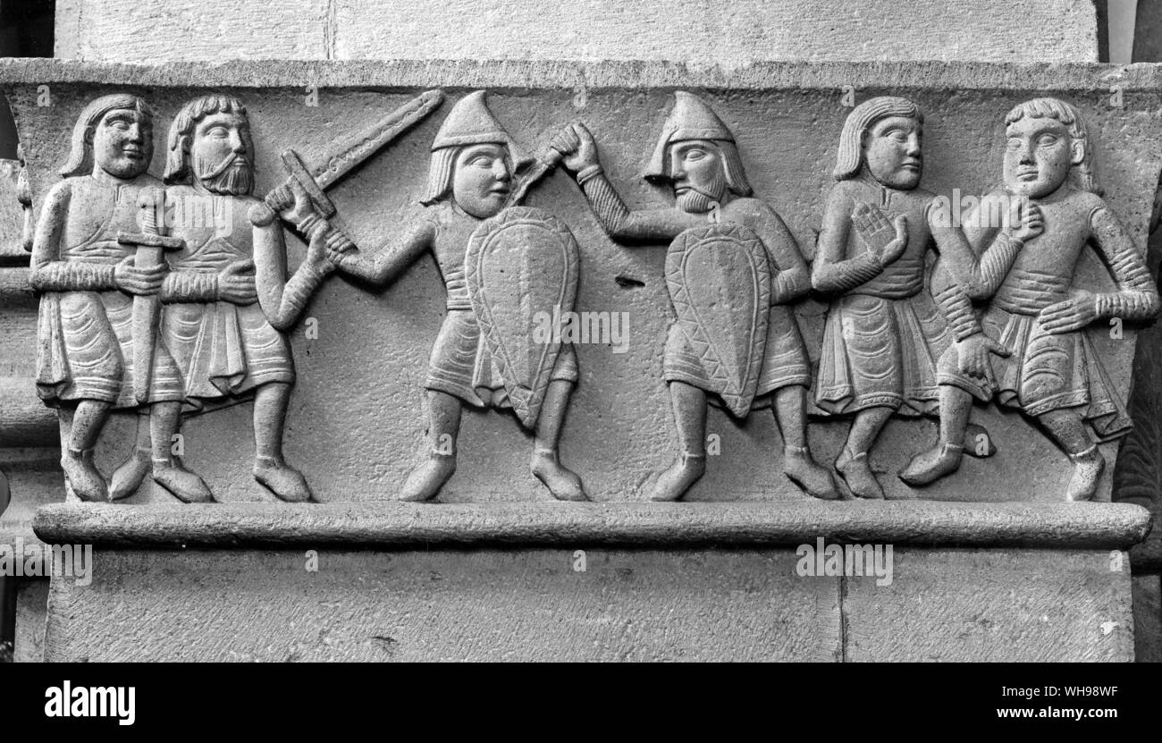 European warfare/Swiss medieval soldiers in stone relief. Stock Photo