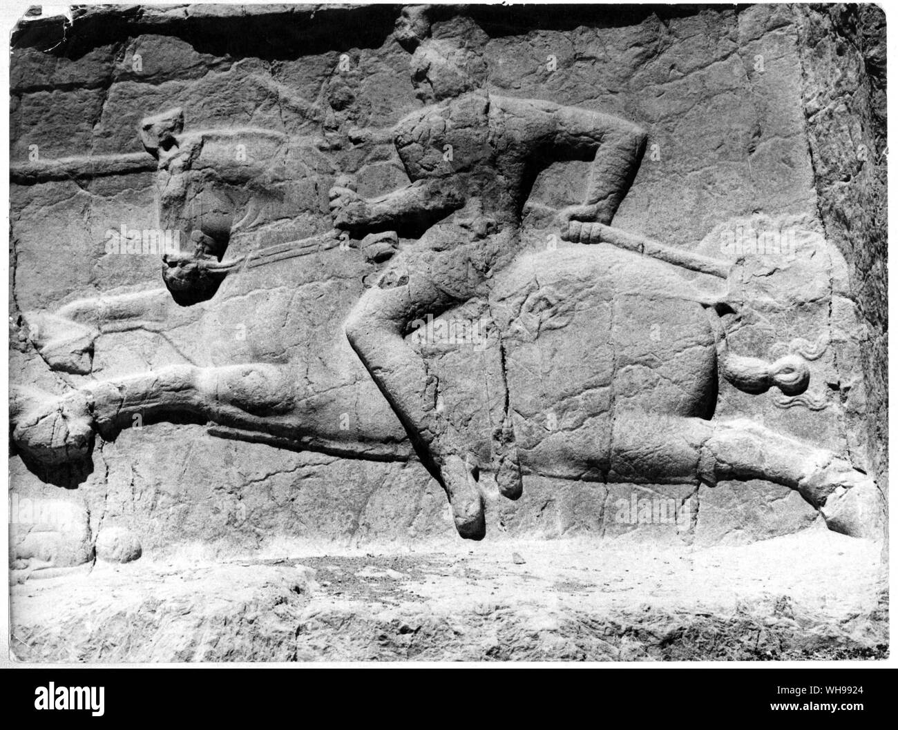 Ancient warfare/Heavy cavalry (depicted in this relief), riding with the aid of a stirrup, were introduced from the east.. Stock Photo