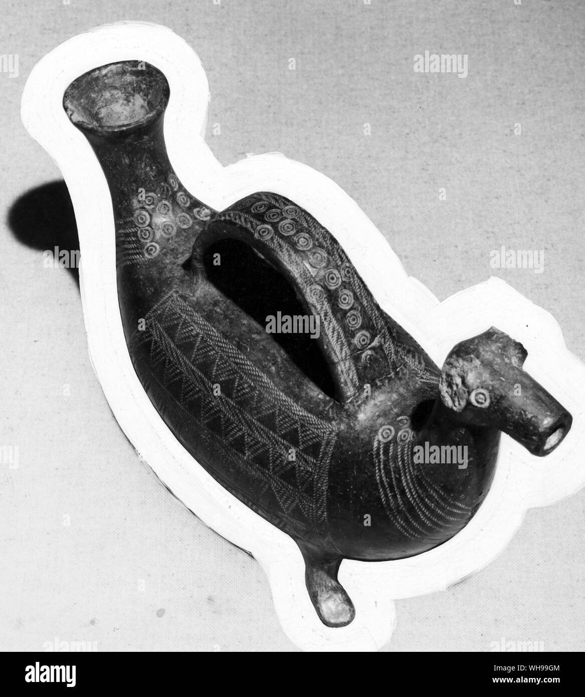 A vessel for wine or oil a rams head at one end and a spout at the other Stock Photo