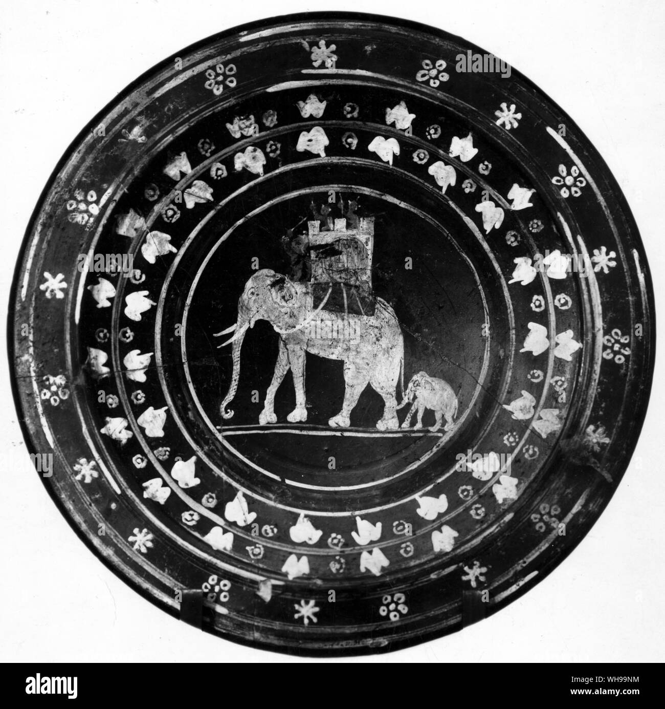 War elephant followed by a calf decoration on an Etruscan plate dated mid 3rd century BC Stock Photo