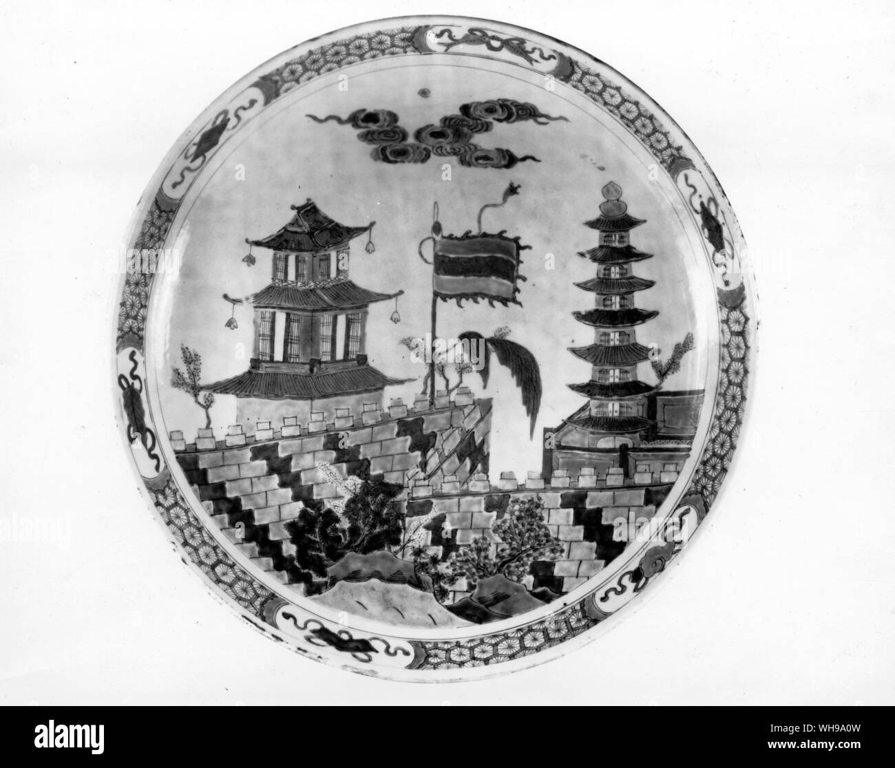 A Chinese famille verte dish made for export to Europe in the early 18th century, showing a pavilion and pagoda with upswept roof-lines. Stock Photo