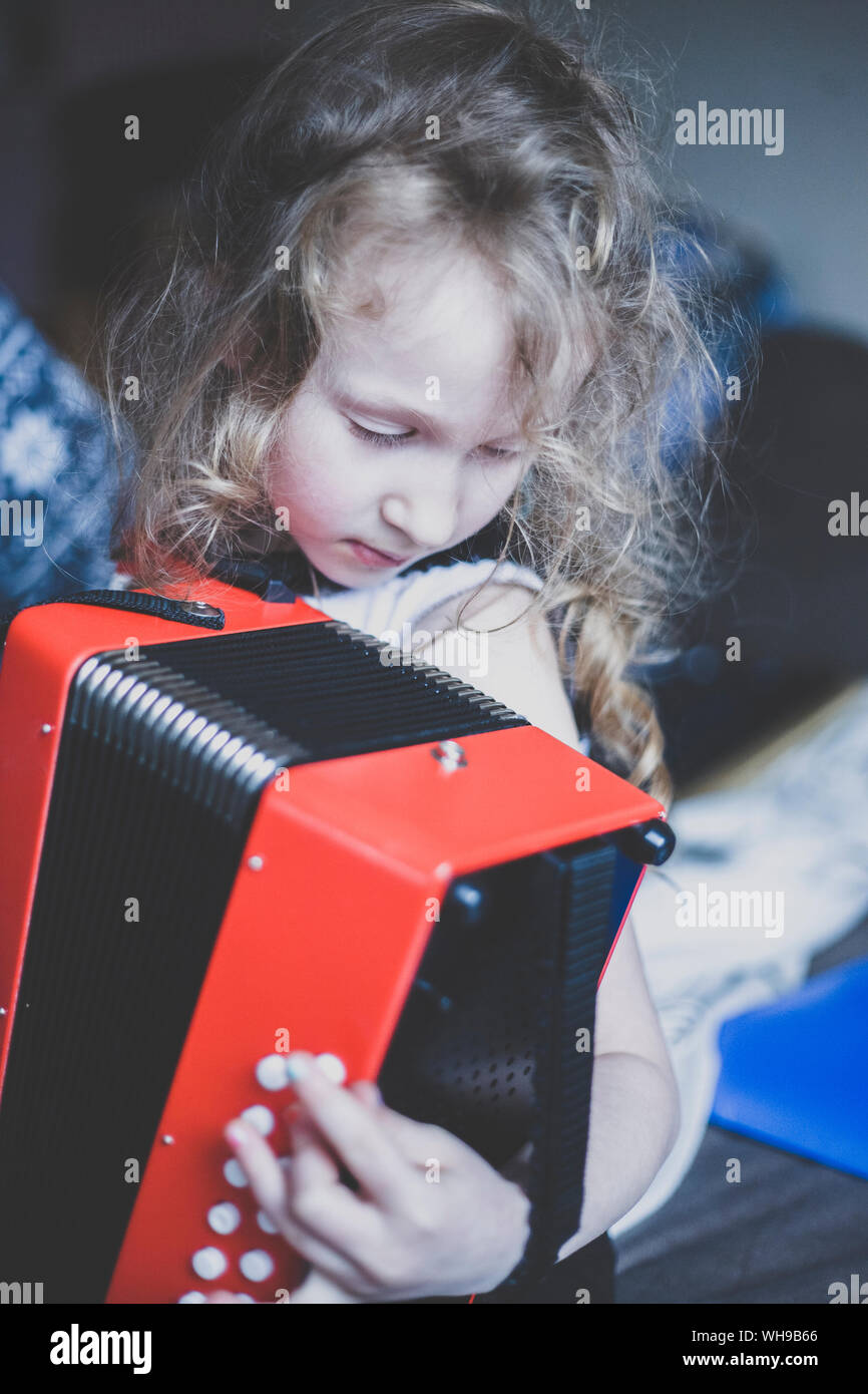 Little girl playing accordeon Stock Photo