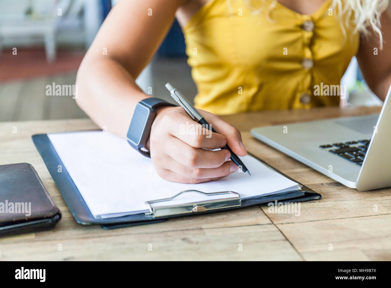 Woman hand writing on clipboard, close-up Stock Photo