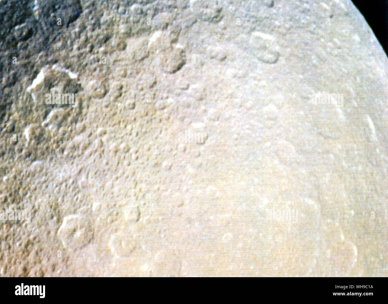 Space Saturn. Saturnian moon. Rhea, crated surface. Stock Photo