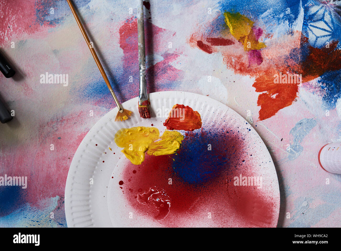 Paint palette with various acrylic paints and a brush Stock Photo