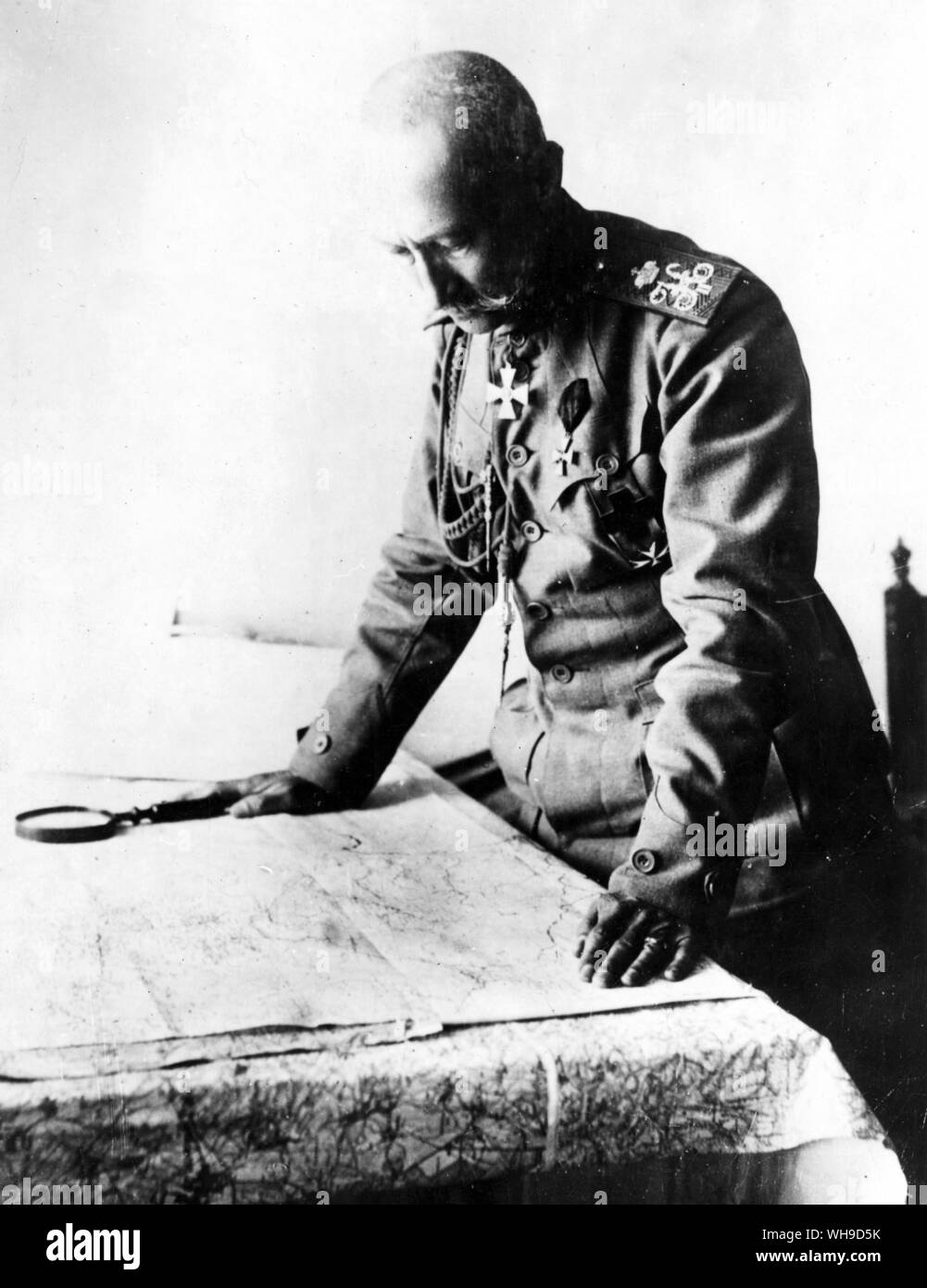 Russian General, Aleksei Alekseevich Brusilov (1853-1926). Military leader in World War I, who achieved major success against the Austro-Hungarian forces in 1916. Here, he studies the situation on a map, November 1917. Stock Photo