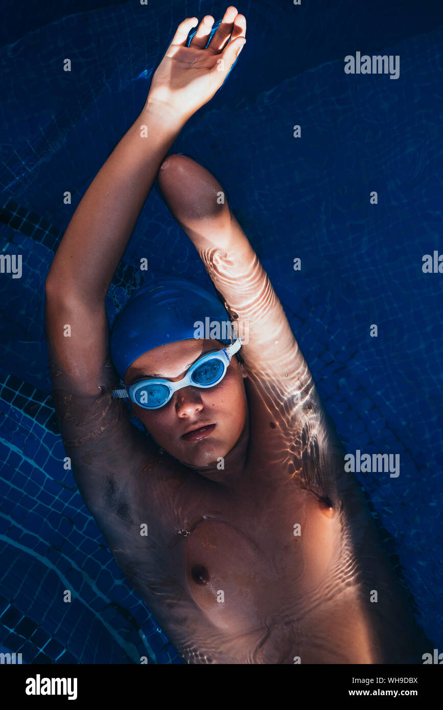 Portrait of paralympic young swimmer floatin on water in a pool Stock Photo