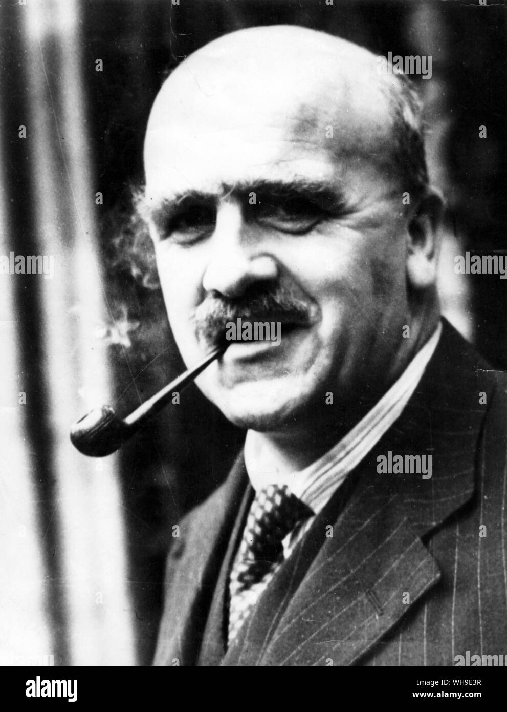 November 1956: British scientist, Professor John Burdon Sanderson Haldane (1892-1964) at the University College, London. Physiologist, geneticist and author of popular science books. In 1936, he showed the genetic link between haemophilia and colour blindness. Stock Photo