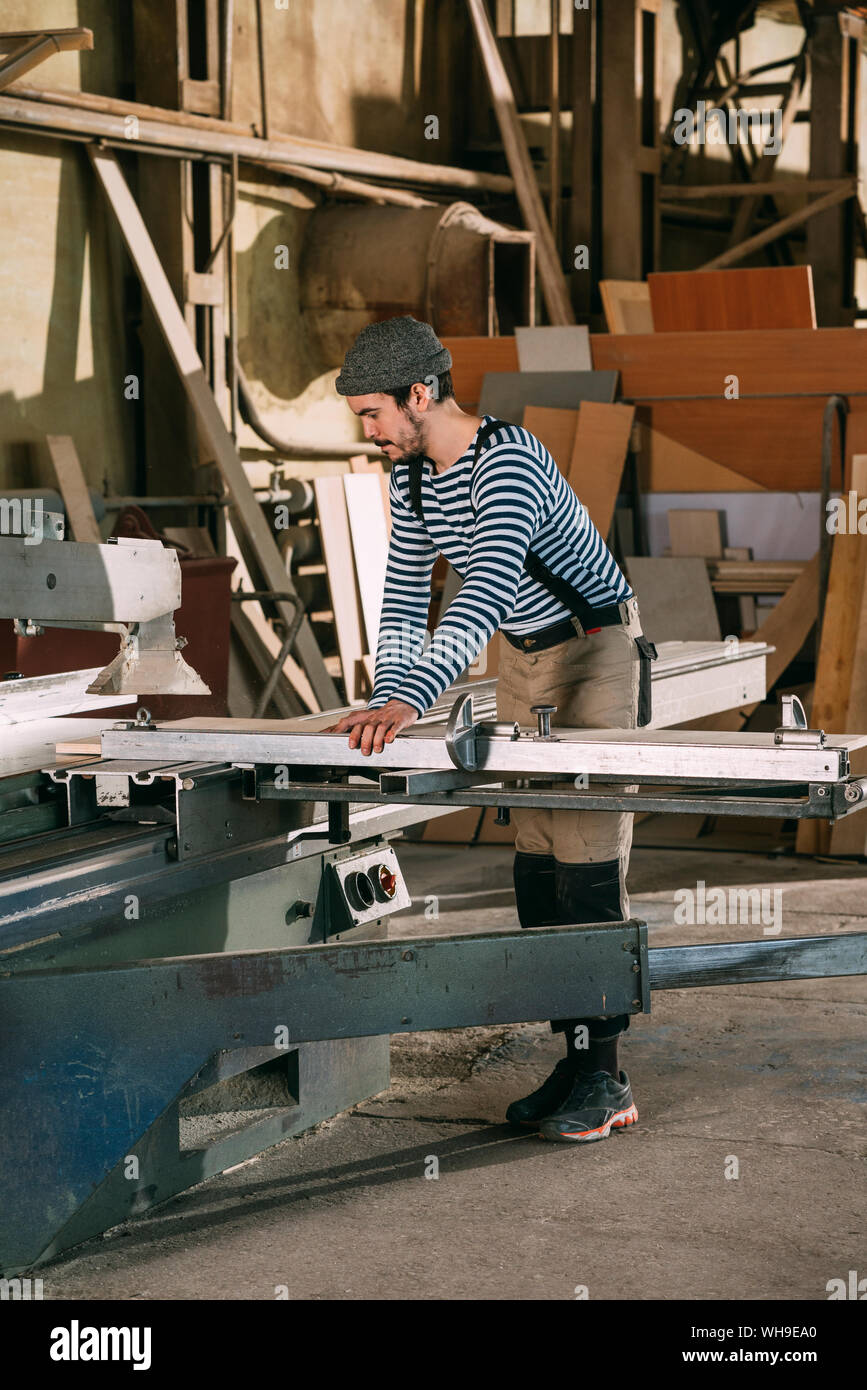 Carpenter working on a saw Stock Photo