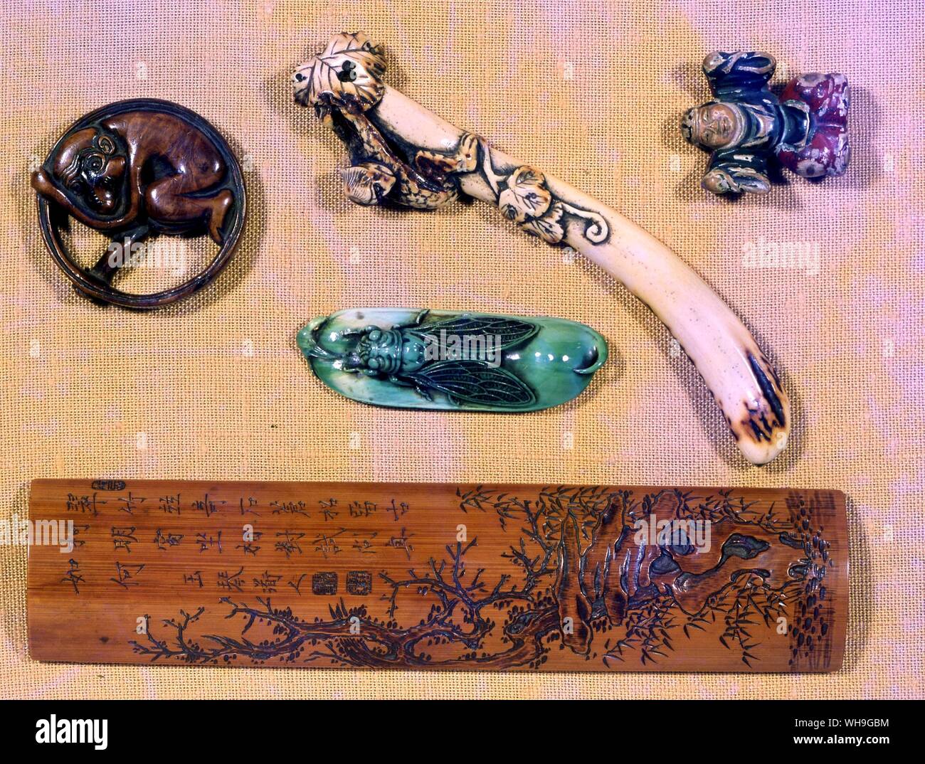 Jewellery bamboo handrest by a literary netsuke carver who was a musician, stagshorn cucumber, a hanging netsuke, green stained ivory cicada monkey in a ring an early netsuke perhaps about 1740 a painted netsuke of a dancng boy Stock Photo