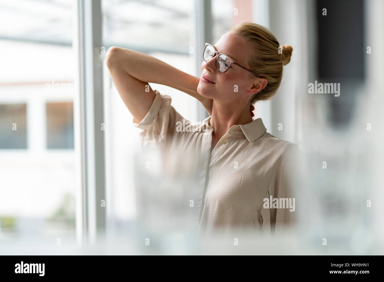 Young businesswoman having a break at the window Stock Photo