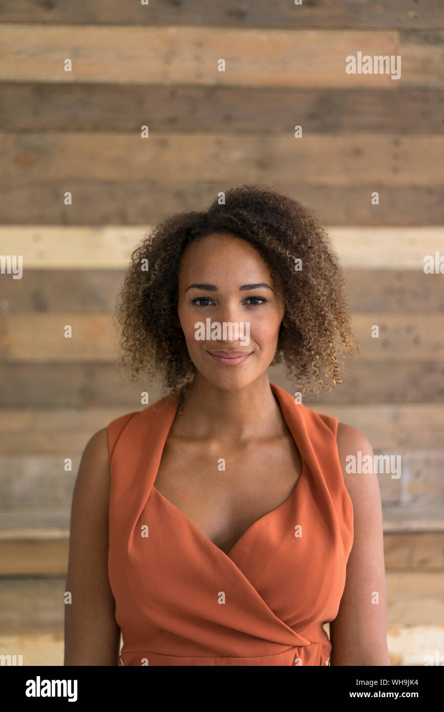 Portrait of smiling young woman with ringlets Stock Photo
