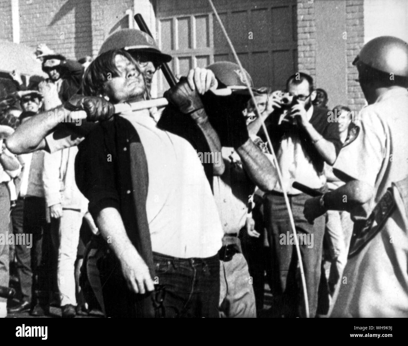 20th Oct. 1967: Oakland: A policeman uses his night stick to stop antics of an anti-draft demonstrator at Oakland Army Induction Centre. 10,000 demonstrators were on hand during the fifth day of protest there. Stock Photo