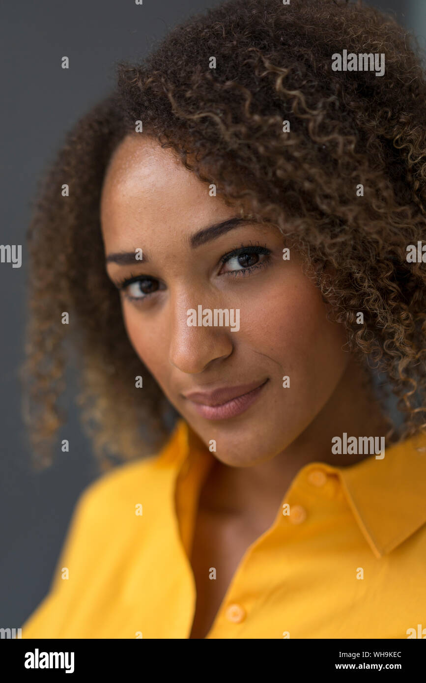 Portrait of young woman with curly hair Stock Photo