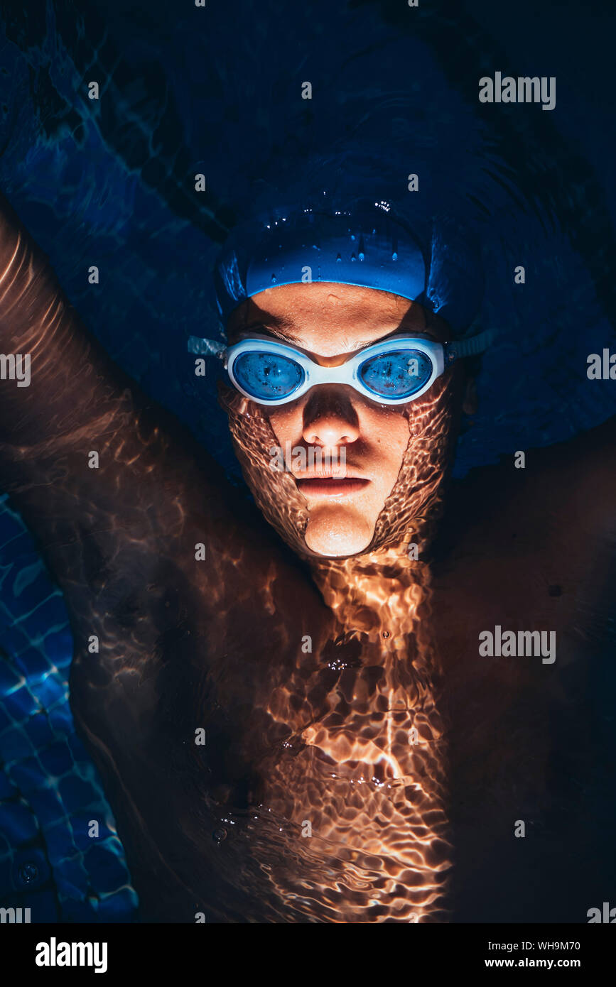 Portrait of paralympic young swimmer floating on water in a pool Stock Photo