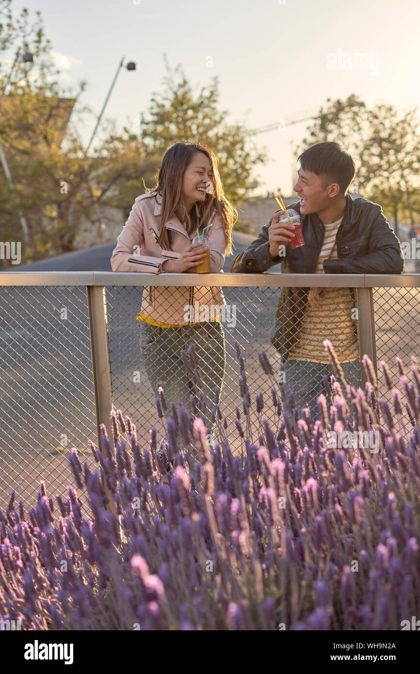 Couple with soft drinks having fun together in the evening Stock Photo