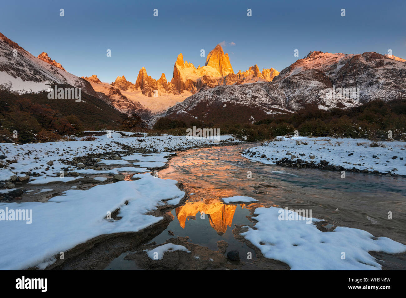 Mountain range with Cerro Fitz Roy at sunrise reflected in river, Los Glaciares National Park, UNESCO, El Chalten, Patagonia, Argentina, South America Stock Photo