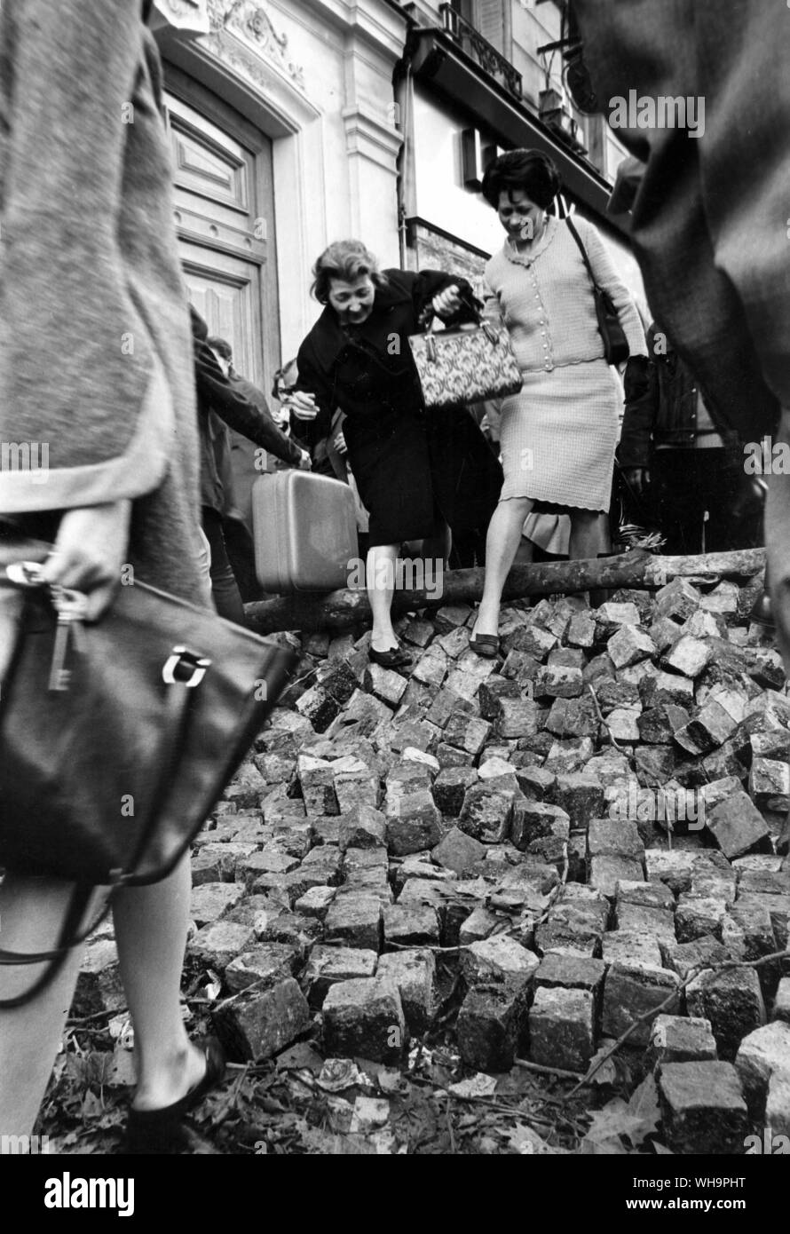 Paris Riots, 25th May 1968: Parisians scramble over piles of cobble stones torn up to build barricades with. Stock Photo