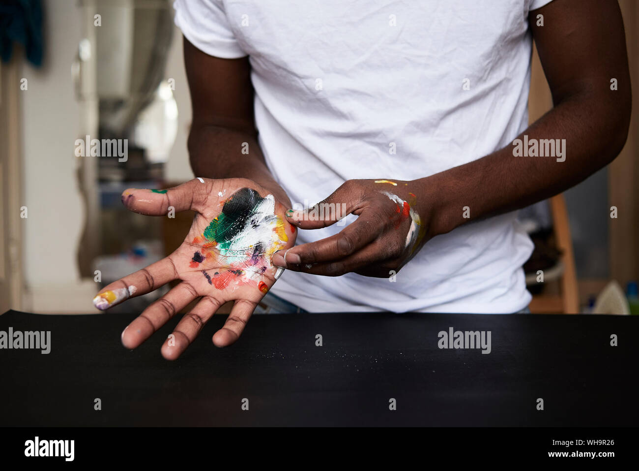 Dirty hands of artist with colorful paints, close up Stock Photo