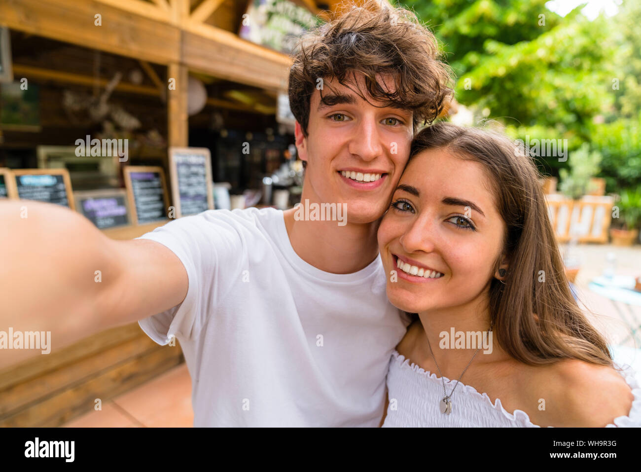 Young couple taking a selfie at a cafe Stock Photo