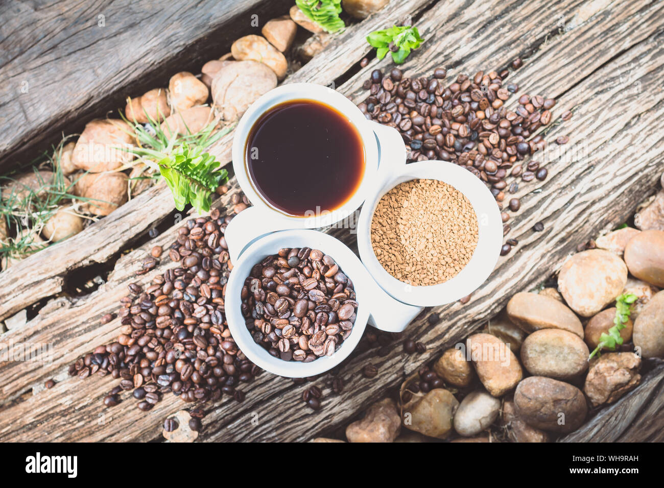 Directly Above Shot Of Coffee Cup With Roasted Beans And Caffeine In Cups On Wood Stock Photo